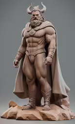 a model figure of a warrior stands on a rock
