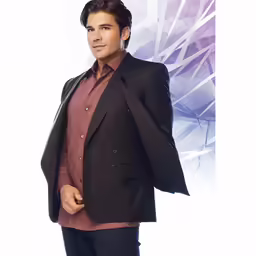 a young man posing for the camera wearing a suit