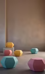 four colorful, rounded stools sitting in front of a wall