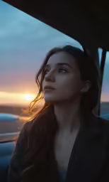 the young girl is looking out of a car
