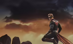 man in black and red outfit standing on rock