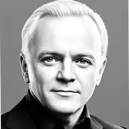 a black and white photo of a man in a suit
