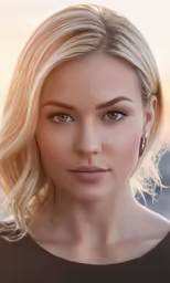 a blonde woman is looking forward with a serious look