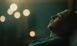 a woman with her eyes closed is looking up