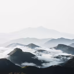 a view of mountains from the top of a hill
