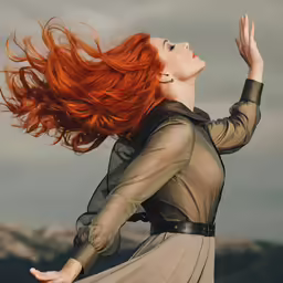 a woman with long red hair walking through the air