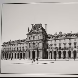a large building is shown in black and white