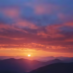 a sunset in the mountains and the sun is shining brightly