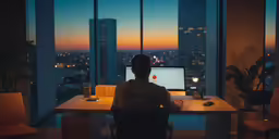 a man works at a computer on his desk