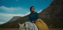 the woman is dressed up and riding on a horse