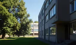a building with grass and trees on the sides
