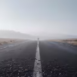 a person walks down a highway with no cars on it