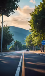a blue car on a street surrounded by trees