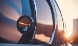 the mirror on the side of the car is reflecting light