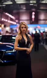 a beautiful young blonde standing next to a blue car
