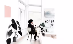 a woman sitting at a desk in a room