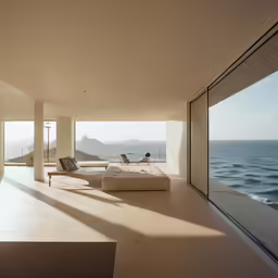 a room with a couch on one side and windows to the other