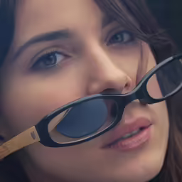a woman is looking into a pair of glasses