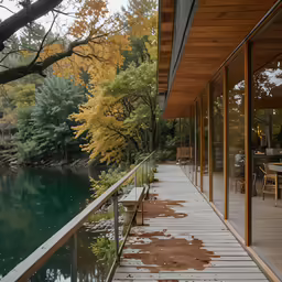 a wooden deck next to a green body of water