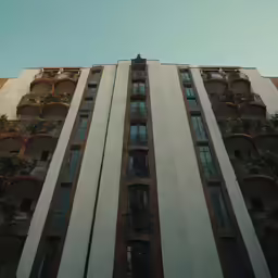 an apartment building with plants growing in windows