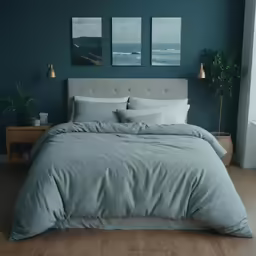 a bed in a bedroom with three pictures on the wall