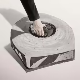 a woman using a hand - held mouse to open a circular duct tape