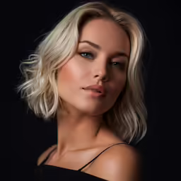 a woman with blond hair and a black top