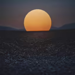 the setting sun shines brightly on the horizon over a barren landscape