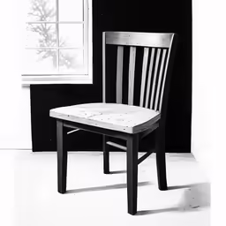 black and white photo of a chair with an open window behind it