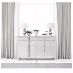 two lamps are on top of a dresser