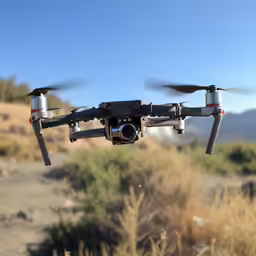 a black and grey remote control airplane flying in the air