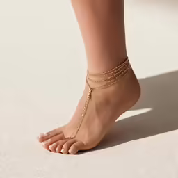 the ankle chain is gold on top of the toes