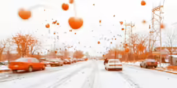 a wintery street full of cars, and lots of snow on the ground
