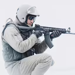 a man in winter gear holding a rifle
