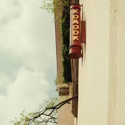 the sign for kodak is hanging out of the building