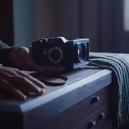 the person is holding the camera near the dresser