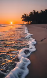 a beach with waves coming in and out of the sand
