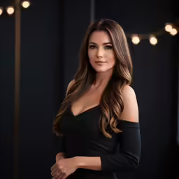 a woman in black with lights above her shoulder and her hands on the waist