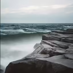 the waves are crashing onto the shore of the ocean