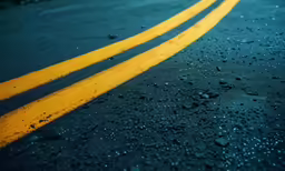 yellow lines are painted on the asphalt of a road