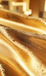 water is flowing over the edge of a wooden table
