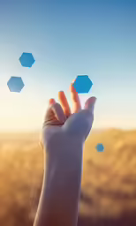 someone is flying something into the air above their hands