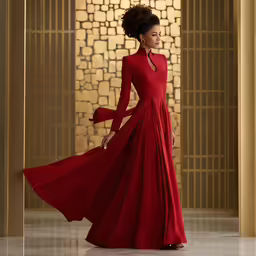 a woman in a red gown stands and looks off into the distance