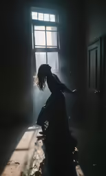 person kneeling on the ground with sunlight coming through a window