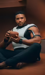 a man holding a football in his hands