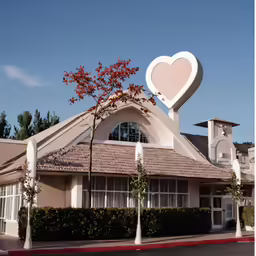 a heart sign atop a church on a hill