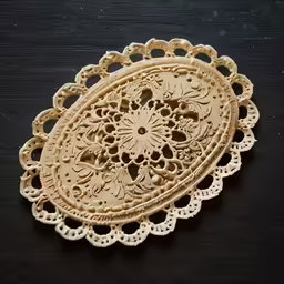 an intricate wooden object sitting on top of a table