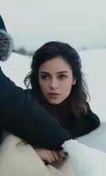 a woman is leaning back in the snow