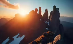 the sun setting on the top of a mountain