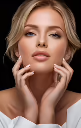 a woman wearing white and black posing for a portrait